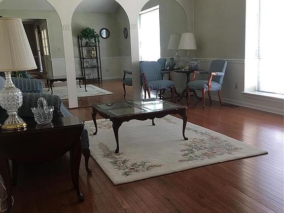 Spacious living room with wood flooring.