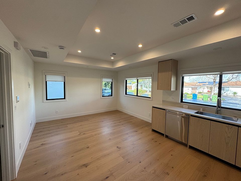Picture shows living area and part of the kitchen.