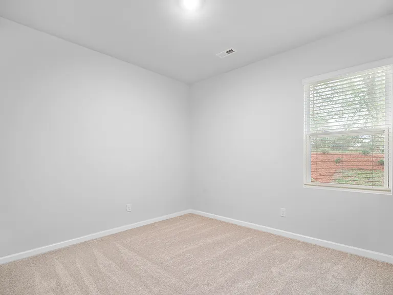 Downstairs bedroom 1 with a ceiling fan.