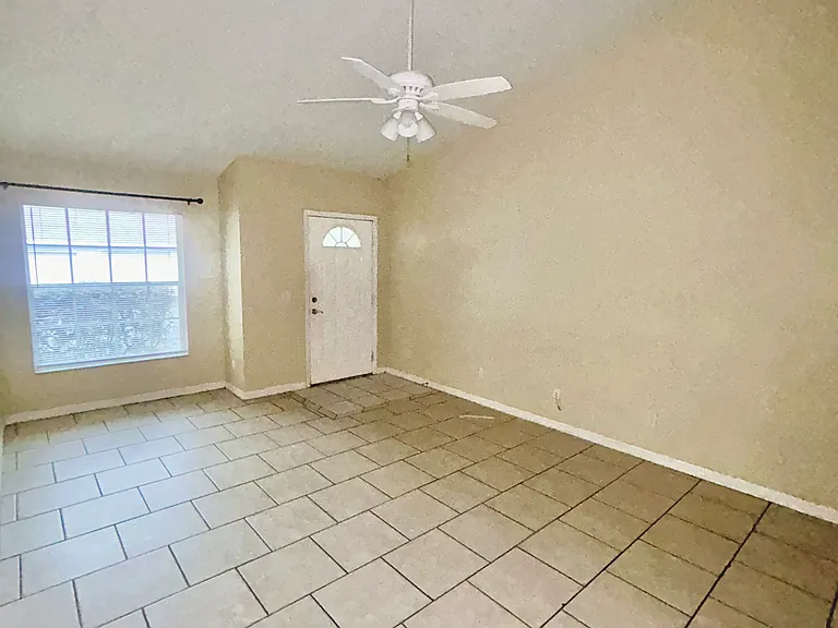 Picture of living room with vaulted ceiling and front door