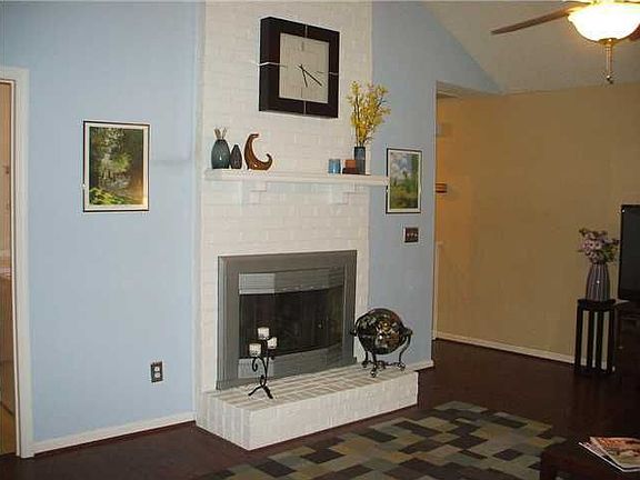 Vaulted ceilings and wood burning fireplace in living room