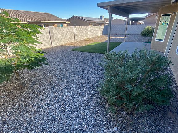 Back Yard , synthetic turf, gravel and landscaping.