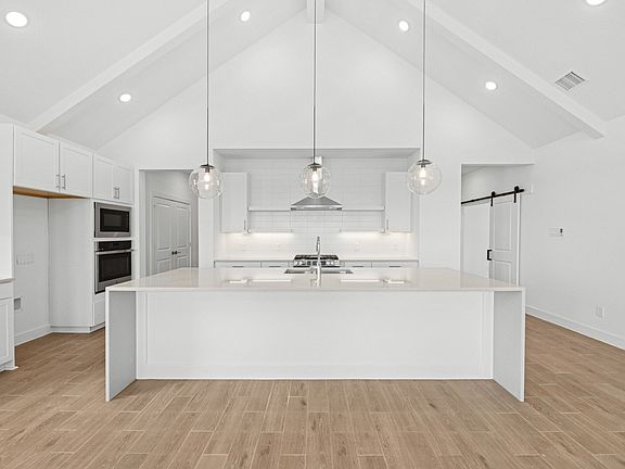 Kitchen with pendant lighting and floating shelves