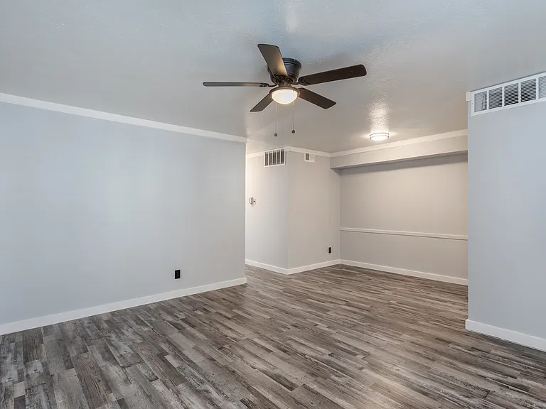 Living room with ceiling fan and updated flooring