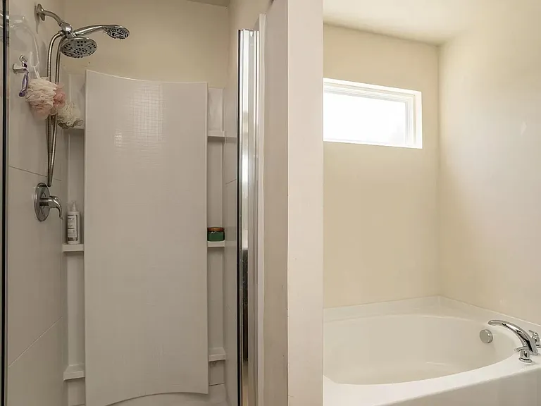 Main bath with separate shower and garden tub.
