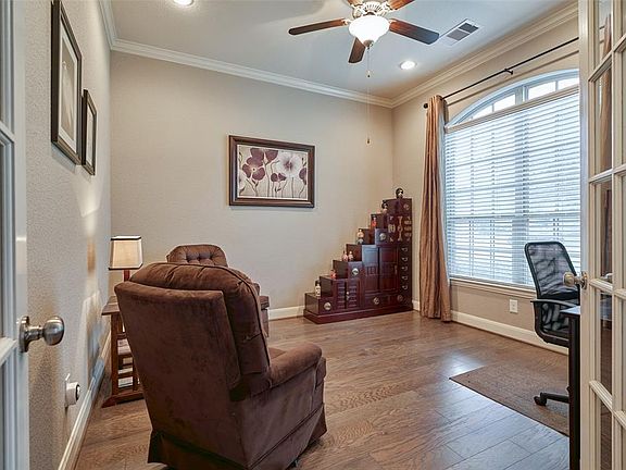 Just off the foyer, the beautiful french doors lead to the spacious office.