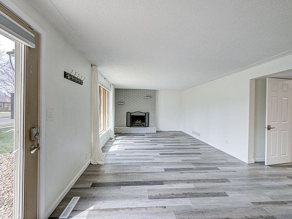 Spacious living room with wood burning fireplace