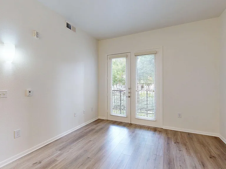 Spacious apartment Bedroom with wood style floor.