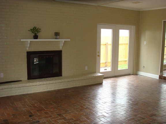 Living area with fireplace and french door to private patio