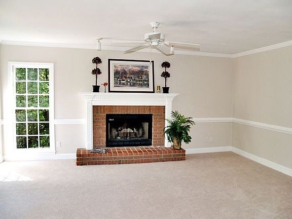 The fireside great room has windows galore, new carpet & fresh paint.
