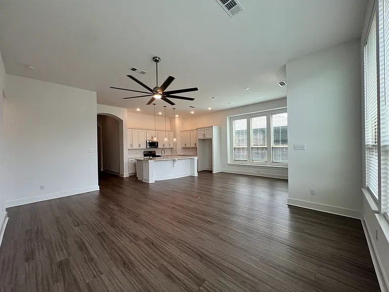 Living room open to kitchen and dining area.