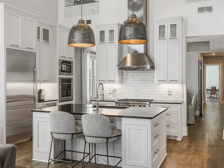 The chef's kitchen boasts a massive island, pantry wall, Wolf steam & convection ovens, a 6-burner 36" gas range and Sub-Zero refrigerator. Everything you need to cook at home, plus island seating and a dining table/room.