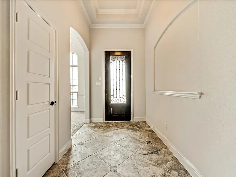Foyer feature glassed wood door, keyless entry & art niche