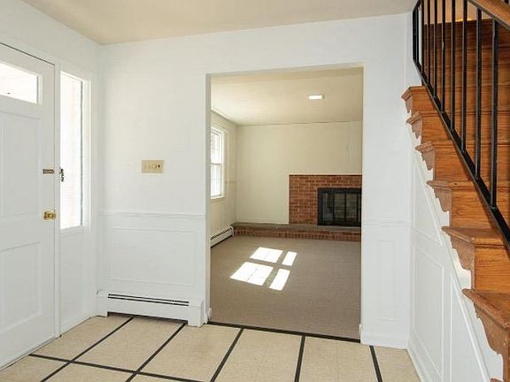 Direct access to a family room with a decorative fireplace.