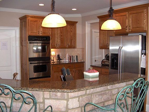 Spacious kitchen features serving bar with unusual stonework