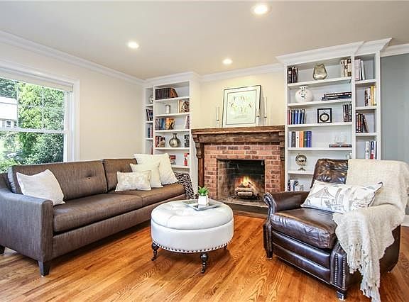 At the far end of the living are attractive built-in bookcases on either side of the fireplace.