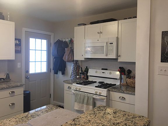 Kitchen with gas stove and microwave.