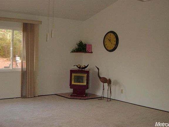 Very spacious family room with a pellet stove and sliding doors to the large back patio.