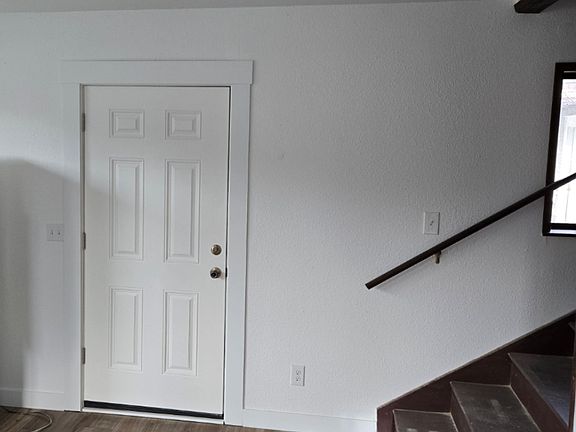 Front door stairs leading to upstairs bedroom