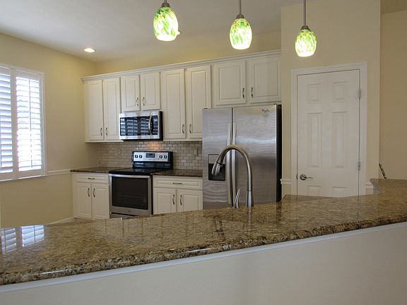 Stunning backsplash and wood cabinets adds to the beauty of this kitchen