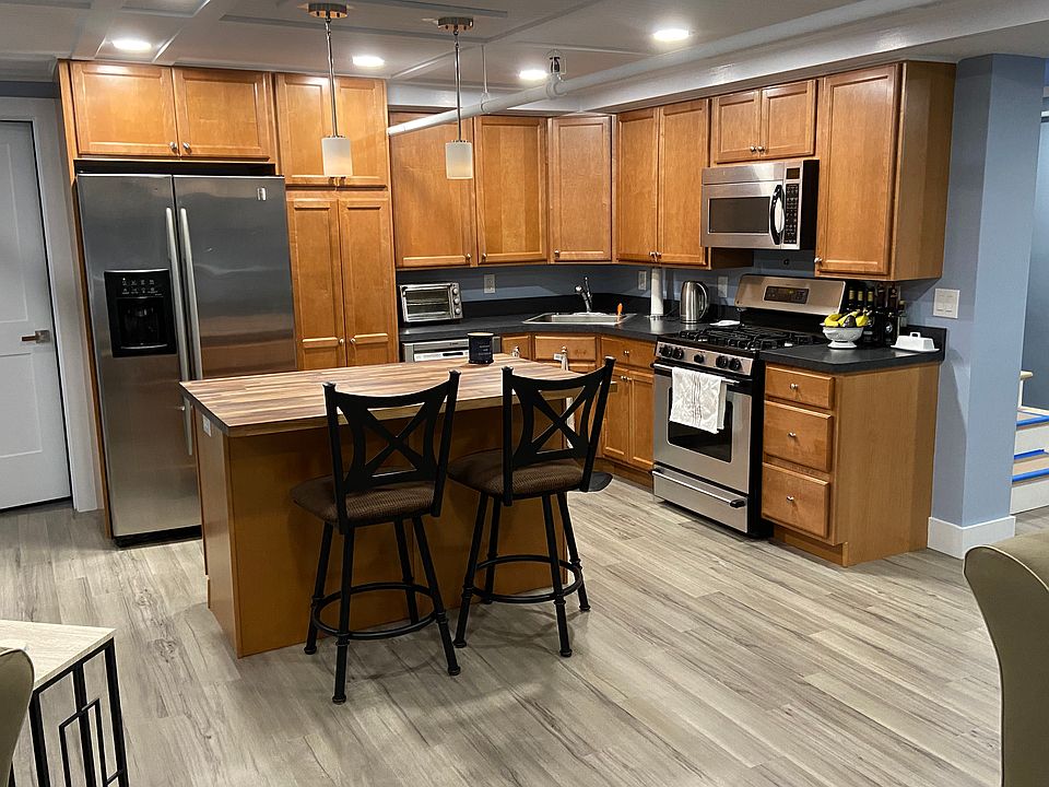 Full kitchen with fridge, range, dishwasher, and island