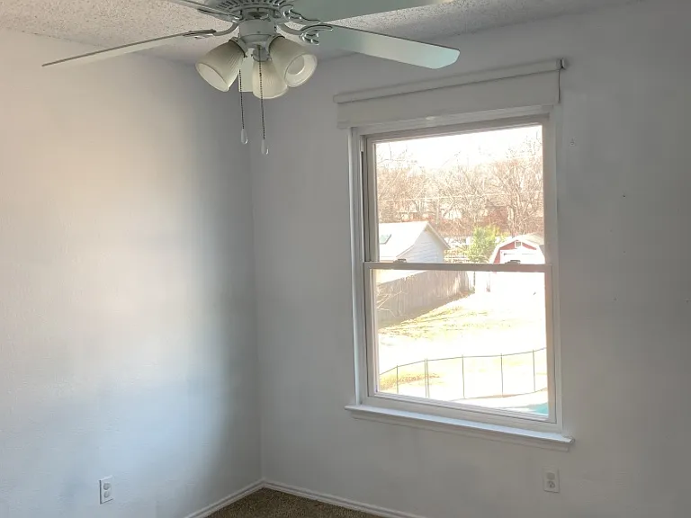 Small bedroom facing backyard