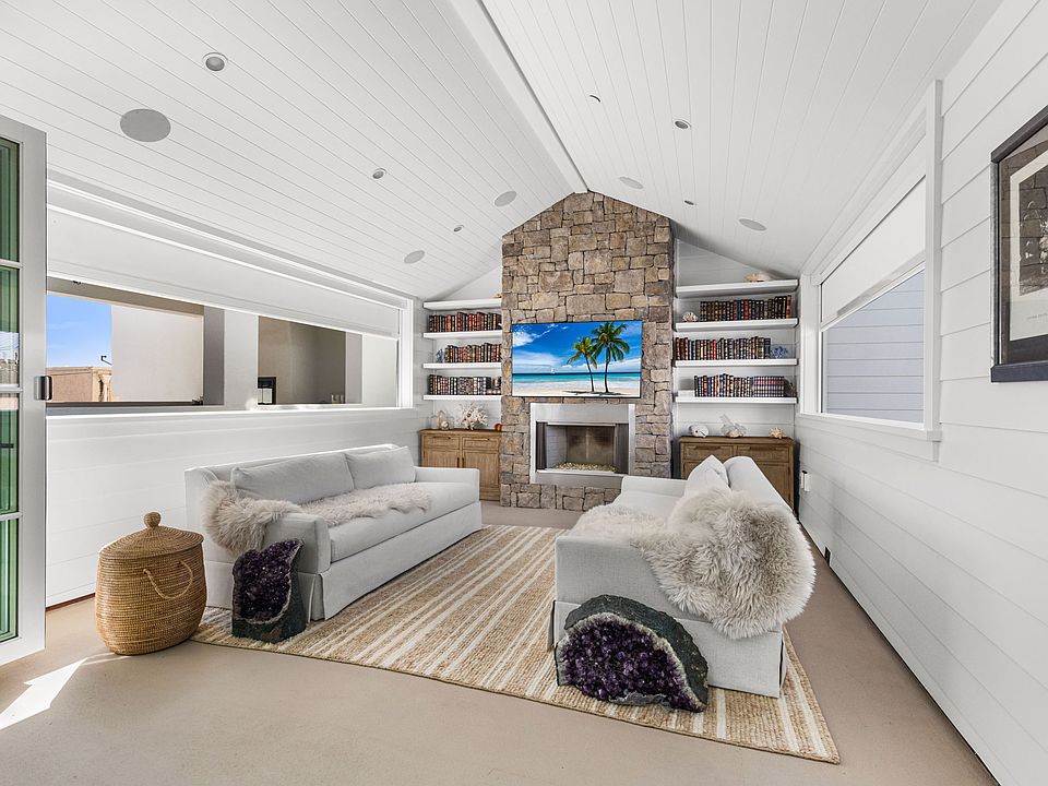 Indoor / Outdoor area with great air flow and electric privacy blinds and a fireplace and TV