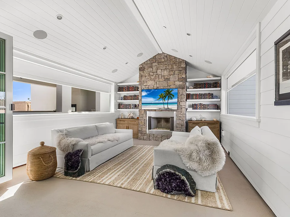Indoor / Outdoor area with great air flow and electric privacy blinds and a fireplace and TV