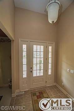 Soaring foyer with tile flooring and doorlight windows