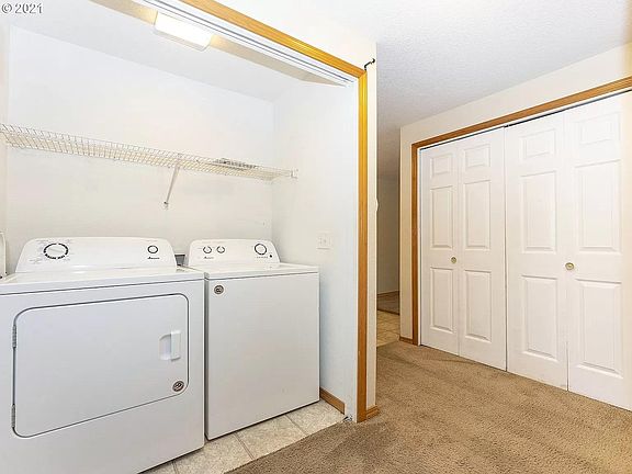 The unit includes an in-unit Washer and Dryer with a large linen closet opposite.
