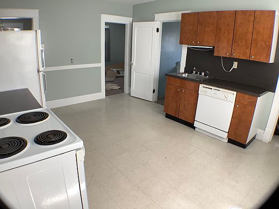 Kitchen with stove, refrigerator and dishwasher.