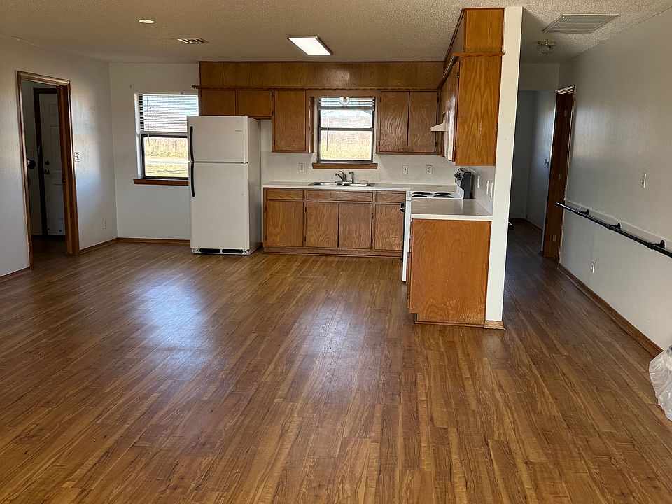 Living room with open kitchen and dining area. New fridge on the way.