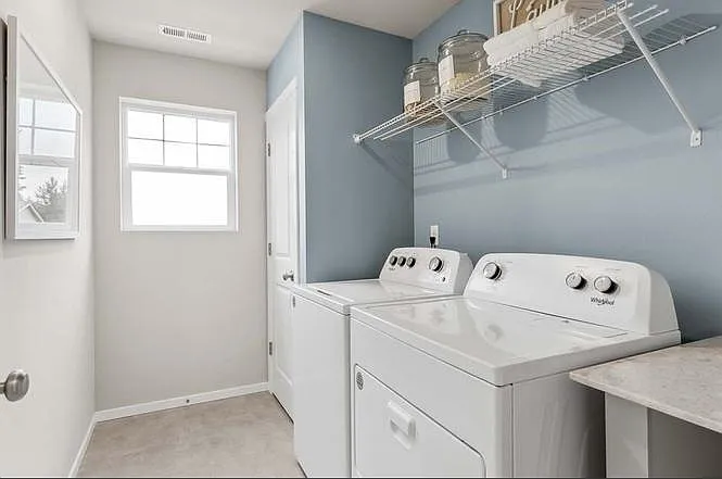 laundry room with closet, countertop, washer and dryer set.