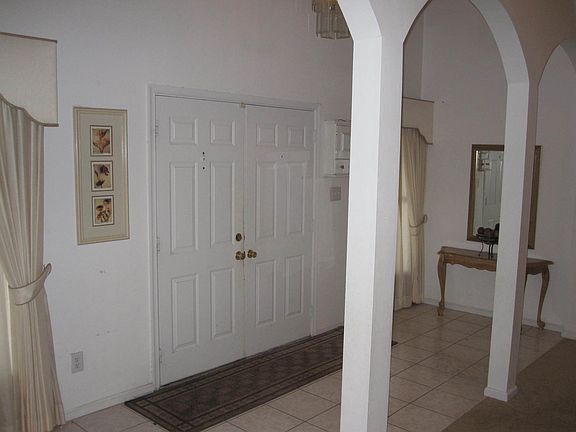 Large Foyer.  Featuring Double Entry Doors, Coat Closet, and Tile Floors.
