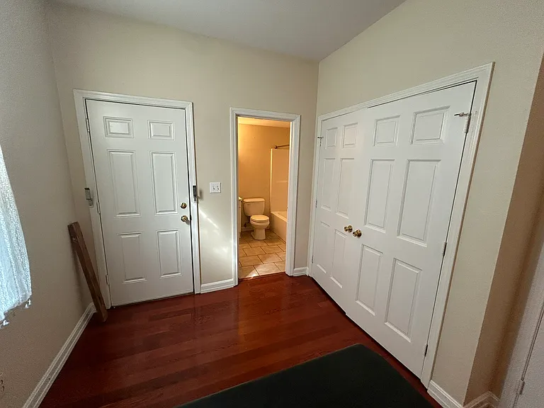 Eating Area, View into Bathroom, and Doors to the Laundry Closet that has hook-ups for Washer and Electrical Dryer