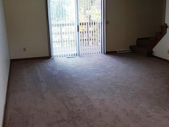 Large living room (new carpet) with walkout to deck.