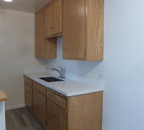 Kitchen: white quartz counter and stainless steel sink