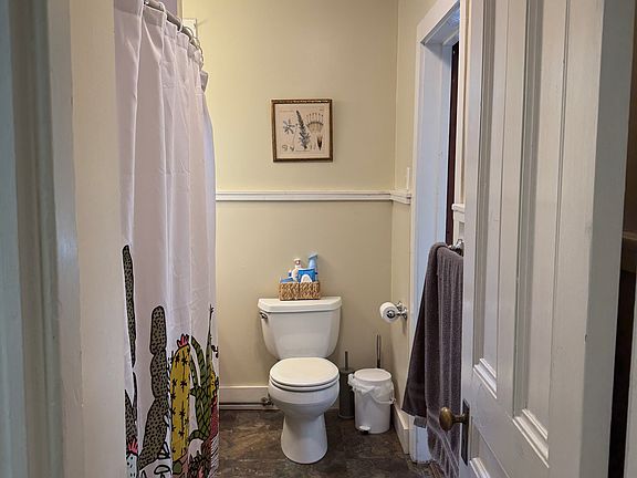 Bathroom right off front entry. The bedroom entrance is through the bath room. You can see the doorway on the right.