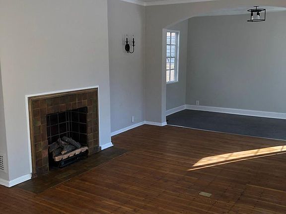 Large living room with hardwood floors and Sunroom with Luxury vinyl tile floor.