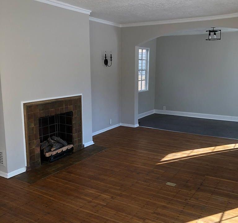 Large living room with hardwood floors and Sunroom with Luxury vinyl tile floor.