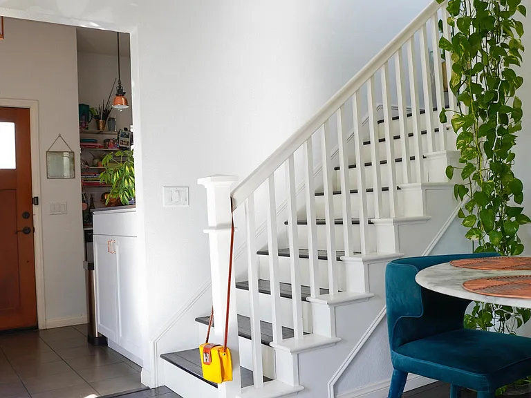 view from dining room towards front door and staircase up to the 2nd floor