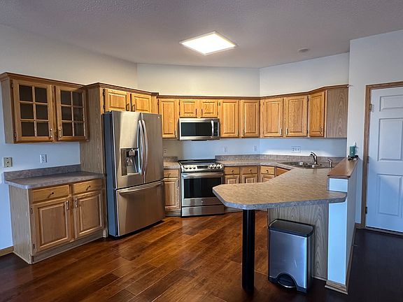 Kitchen with updated appliances and entry door on the right