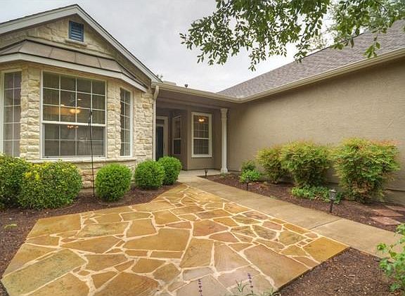 A flagstone Courtyard is viewed from the bay-windowed Breakfast Room.