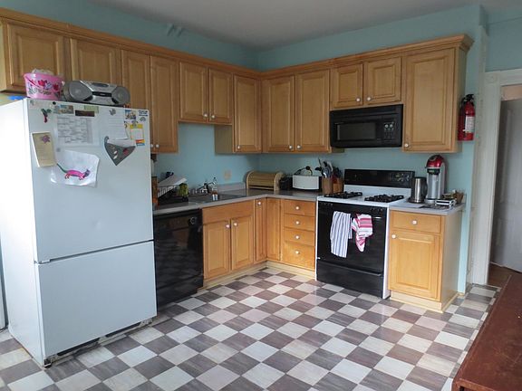Kitchen a few years ago with old Pergo floor. The new floor is just grey laminate slate like tiles.
