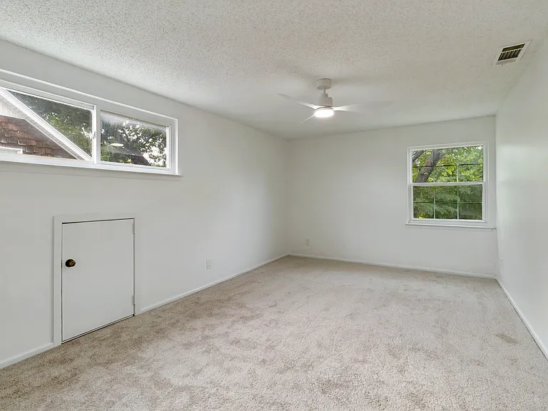 Bedroom 4 with en-suite bathroom. Spacious enough to serve as a second primary suite. Large walk-in closet.