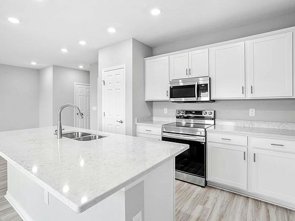 Your bright, open kitchen is centered around an island, and includes a convenient pantry - Blakely b