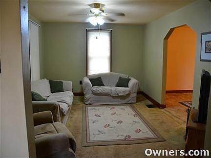 Living room, carpeting removed. Dark hardwoods redone.