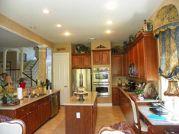Large island kitchen has plenty of cabinet & counter space.