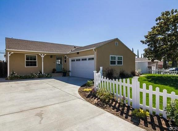 Great curb appeal with the newer driveway, landscaping, and whit