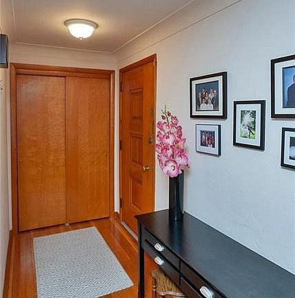 Spacious coat closet and gleaming hardwood floors greet you upon entry.